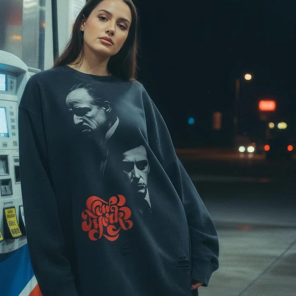 Unisex oversized crewneck sweatshirt in a black snow wash finish, made from 100% premium cotton. This vintage-inspired pullover features a large graphic of iconic movie characters and 'New York' in a red, retro bubble font. With a distressed raw edge hem, frayed details, and a relaxed fit, it offers a high-quality, lived-in feel perfect for authentic streetwear or film-inspired fashion